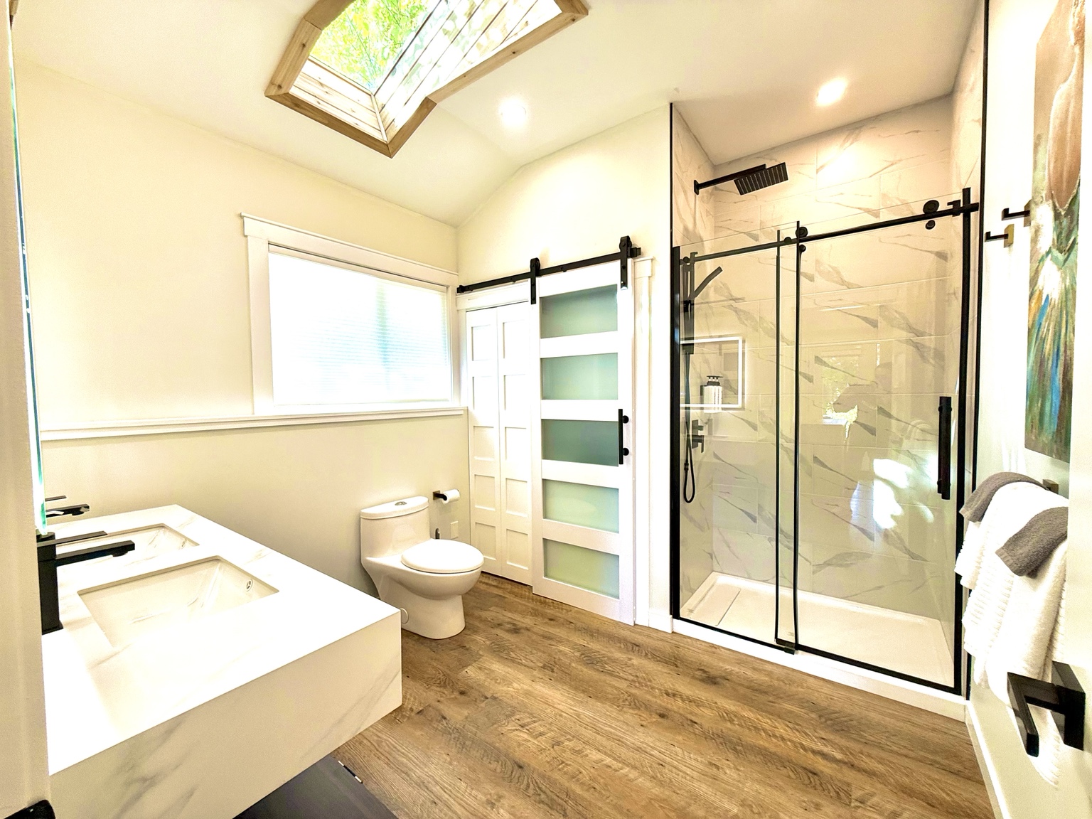 The spa bathroom with double vanity and glass shower at Ravens Nest